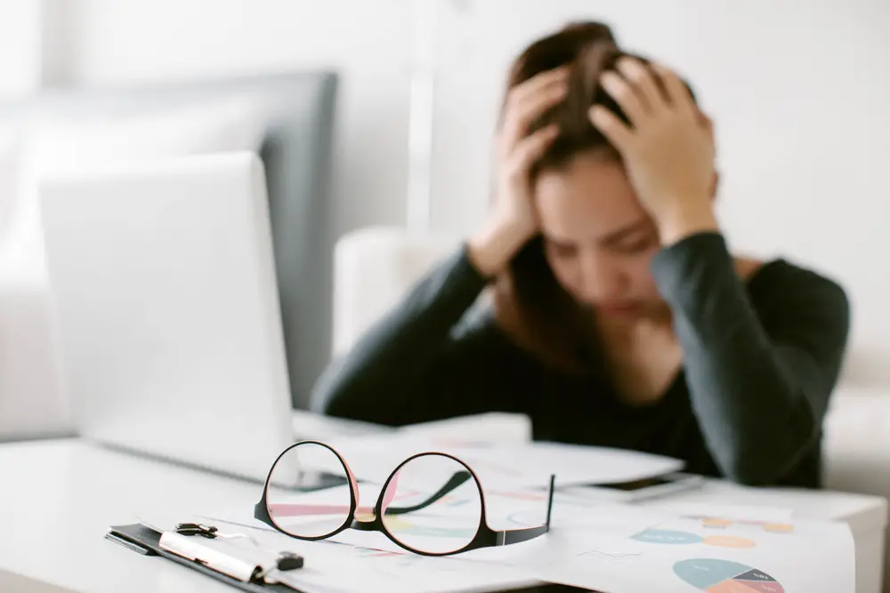 Stressed out woman sitting in front of a computer